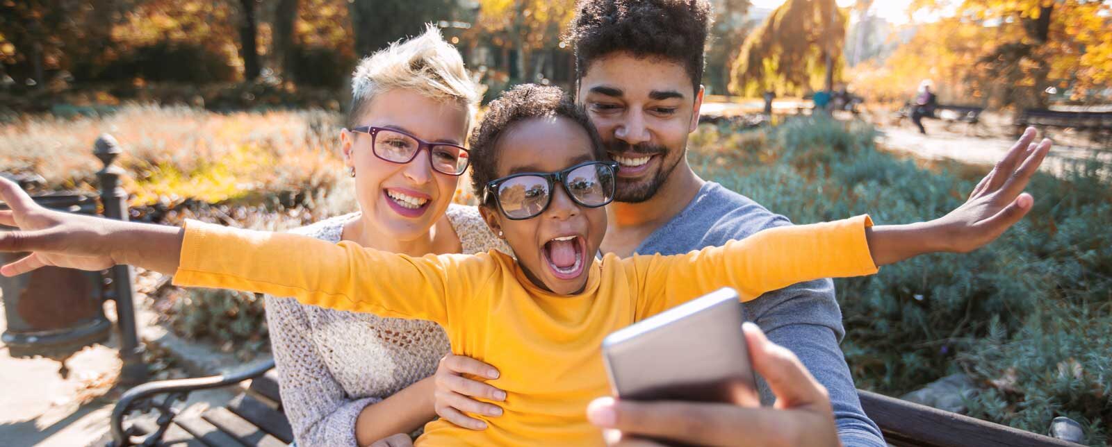 FAQs Frequently Asked Questions - Family at a park taking a selfie
